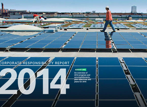 Workers installing solar panels on a warehouse rooftop