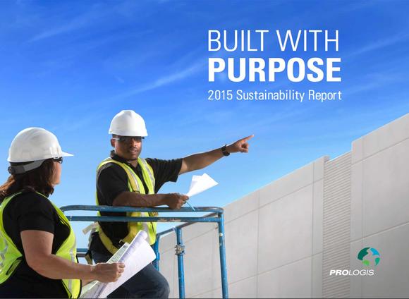 Two workers in hard hats pointing toward a Prologis building