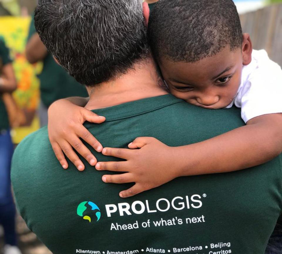 Child hugs a Prologis Employee on IMPACT Day