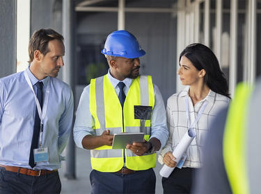 A team member walks visitors through a distribution center