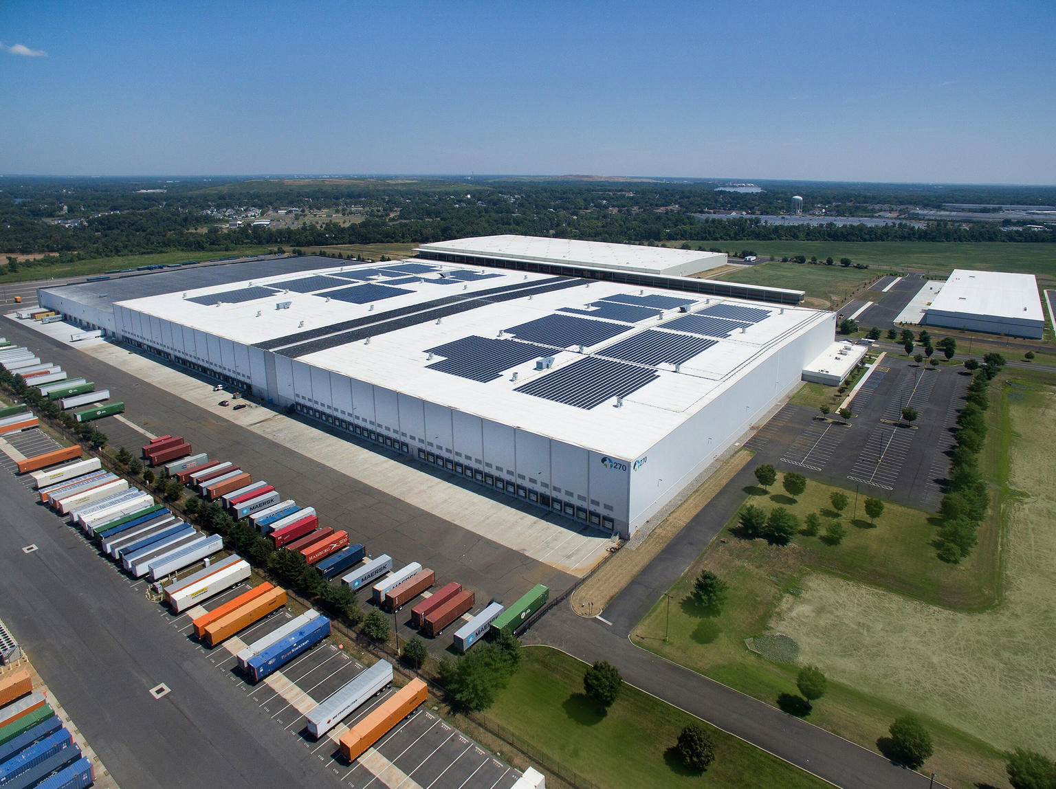 Aerial view of a Prologis building surrounded by grass and blue sky