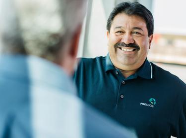 Maintenance technician David Huajardo smiling at a coworker