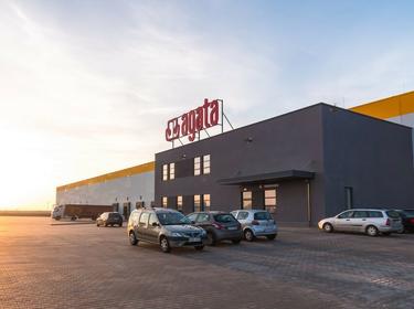 Exterior photo of Prologis Park Piotrkow II at sunset, with cars parked out front