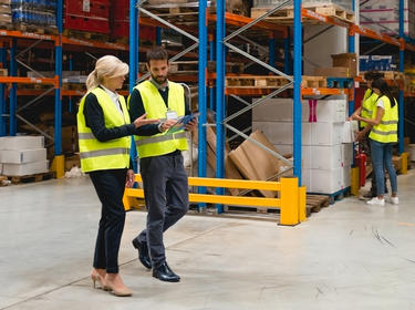 Team members walking in a warehouse