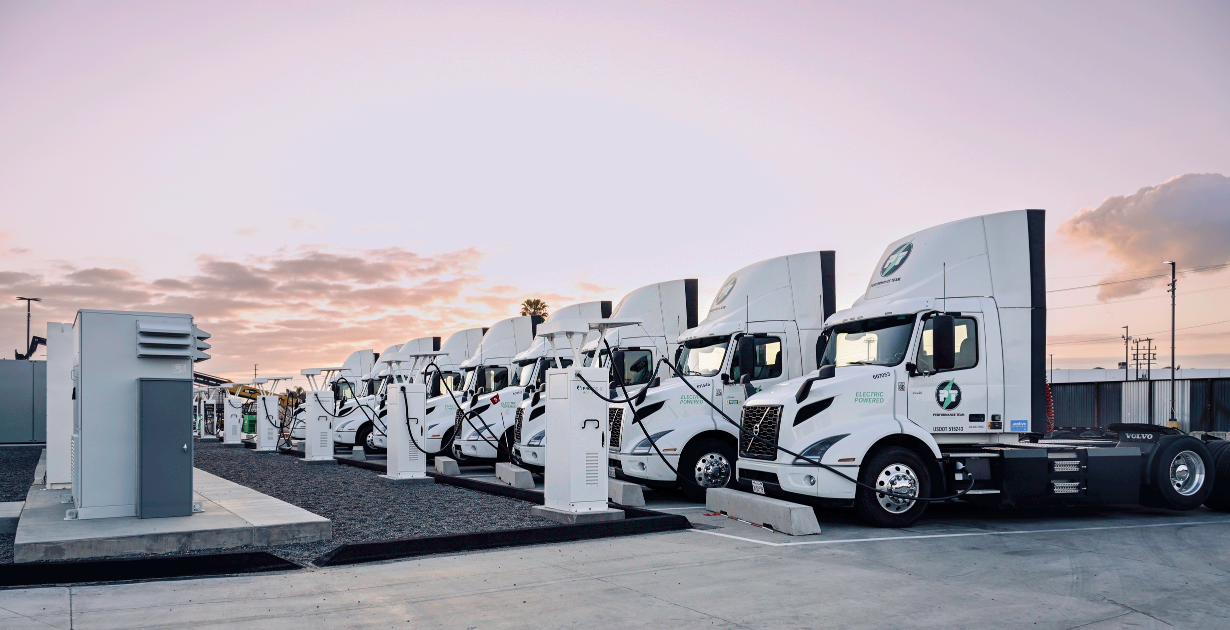 EV trucks lined up at dusk