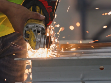 Person using a hand-held saw.