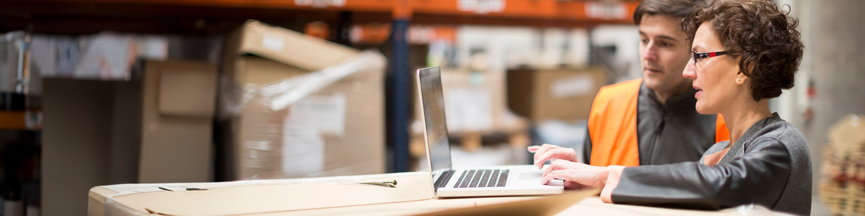 woman on laptop in warehouse